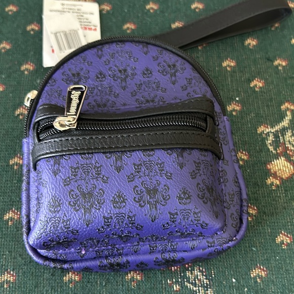 Disney lounge fly Handbags - Disney’s haunted mansion, wristlet, purple, and black has a place foot belt too